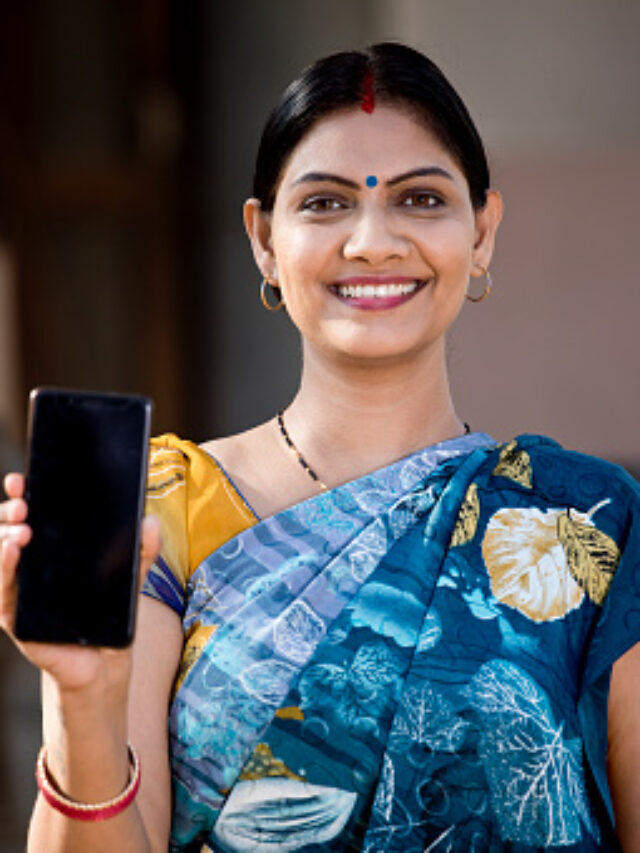 Rural Indian woman in sari showing mobile phone